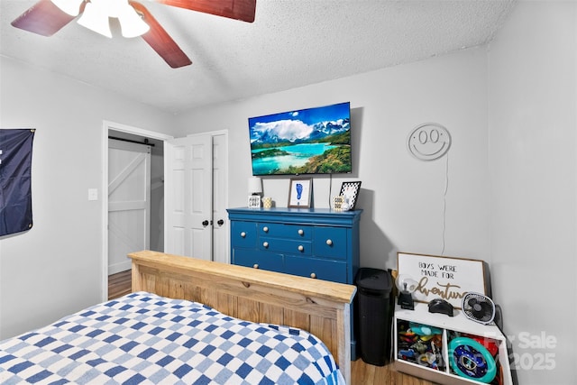 339 Deep Forest Ct, Gastonia, NC 28056 - bedroom with a textured ceiling, wood finished floors, and a ceiling fan