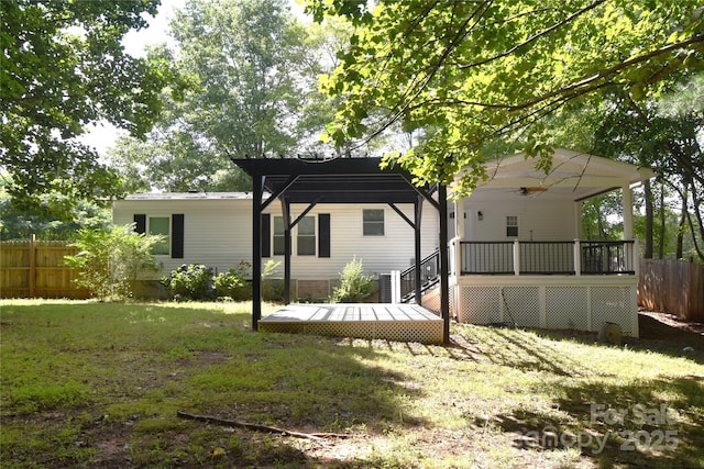 6264 Burnhurst Ln, Denver, NC 28037 - back of property featuring an attached carport, a deck, and a pergola