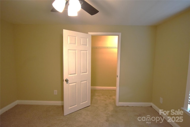 6264 Burnhurst Ln, Denver, NC 28037 - unfurnished bedroom featuring a spacious closet, light colored carpet, and a ceiling fan