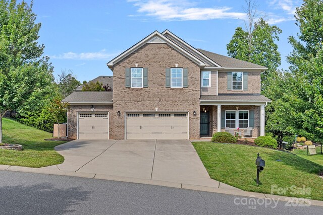 161 Oxford Dr, Mooresville, NC 28115 - view of front of home with driveway, brick siding, and a front yard