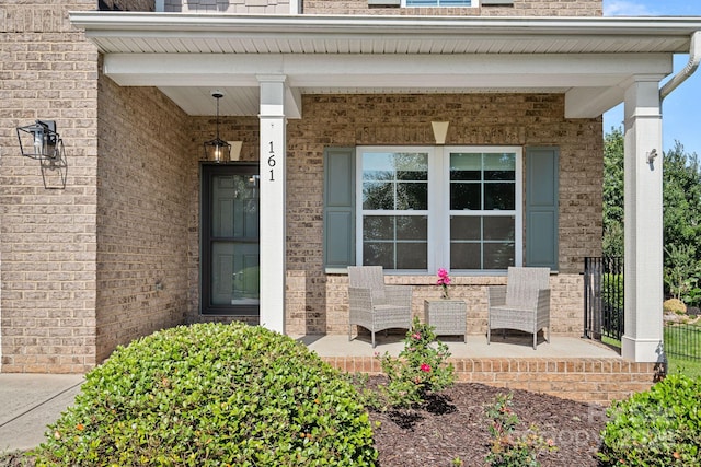 161 Oxford Dr, Mooresville, NC 28115 - property entrance with a porch and brick siding