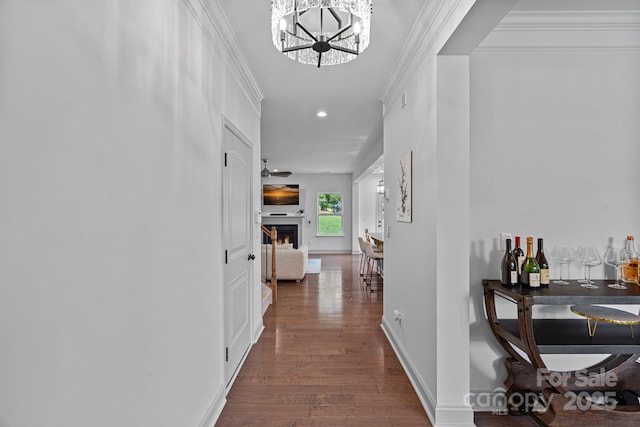 161 Oxford Dr, Mooresville, NC 28115 - hall featuring wood finished floors, recessed lighting, a chandelier, and ornamental molding