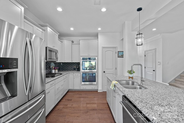 161 Oxford Dr, Mooresville, NC 28115 - kitchen featuring appliances with stainless steel finishes, white cabinetry, tasteful backsplash, recessed lighting, and dark wood finished floors