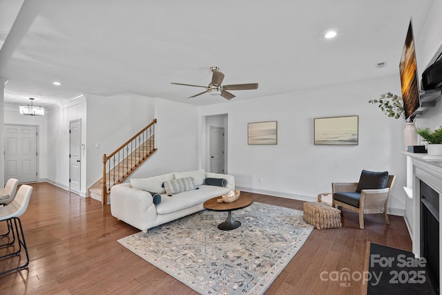 161 Oxford Dr, Mooresville, NC 28115 - living room with a chandelier, stairway, recessed lighting, wood finished floors, and ceiling fan