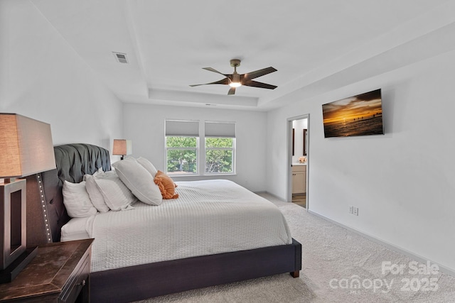 161 Oxford Dr, Mooresville, NC 28115 - carpeted bedroom with a raised ceiling, a ceiling fan, and connected bathroom