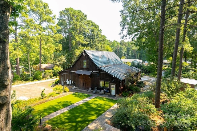 9032 Boyd Dr, Matthews, NC 28105 - view of front of property featuring a metal roof, a front yard, board and batten siding, and a standing seam roof