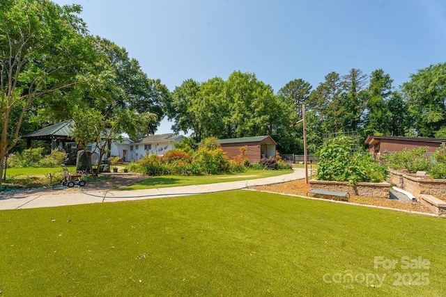 9032 Boyd Dr, Matthews, NC 28105 - view of grassy yard with a vegetable garden and a gazebo