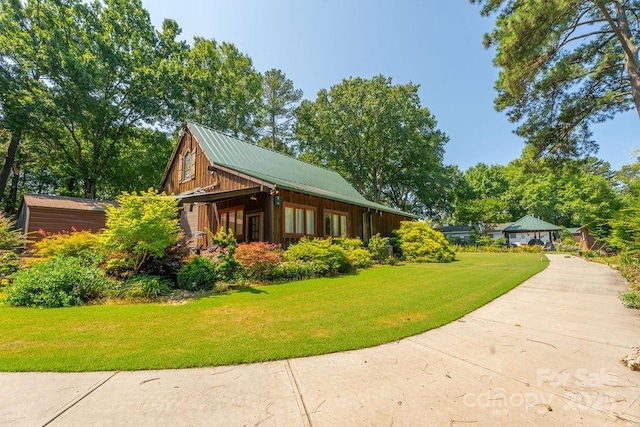 9032 Boyd Dr, Matthews, NC 28105 - view of side of property featuring a lawn and a metal roof