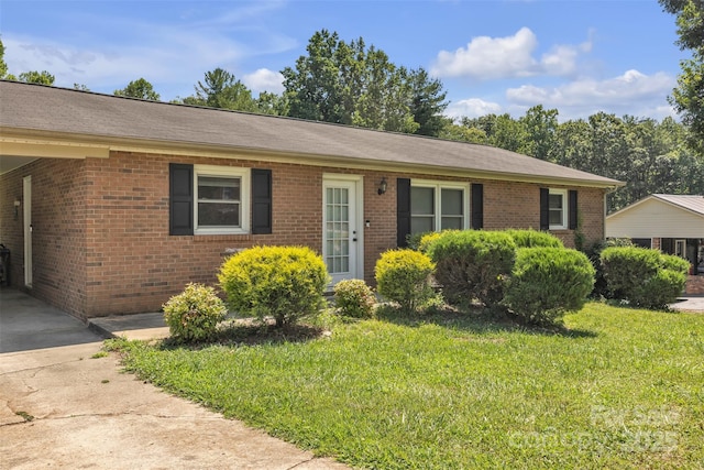 369 Birch Circle Dr, Hudson, NC 28638 - single story home with brick siding, a front yard, driveway, and an attached carport