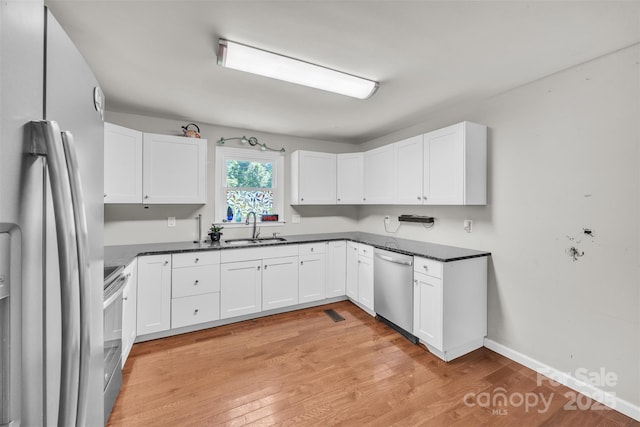 369 Birch Circle Dr, Hudson, NC 28638 - kitchen featuring stainless steel appliances, dark countertops, and white cabinetry