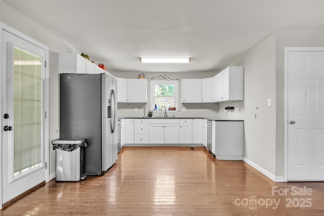 369 Birch Circle Dr, Hudson, NC 28638 - kitchen with stainless steel appliances, light wood finished floors, white cabinets, and dark countertops