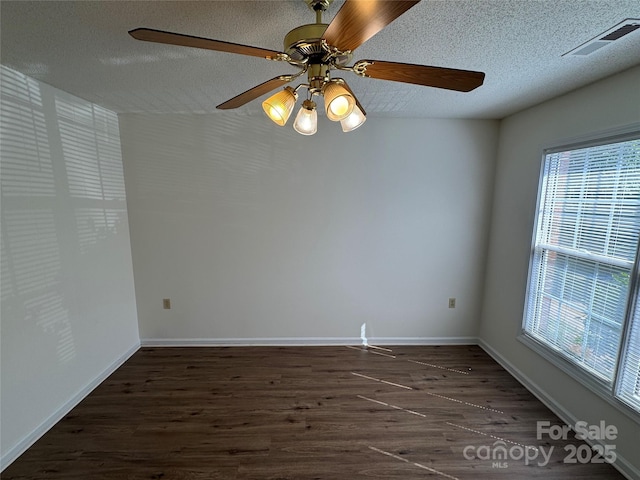 972 NW 8th Ave, Hickory, NC 28601 - spare room featuring healthy amount of natural light, dark wood finished floors, a textured ceiling, and a ceiling fan