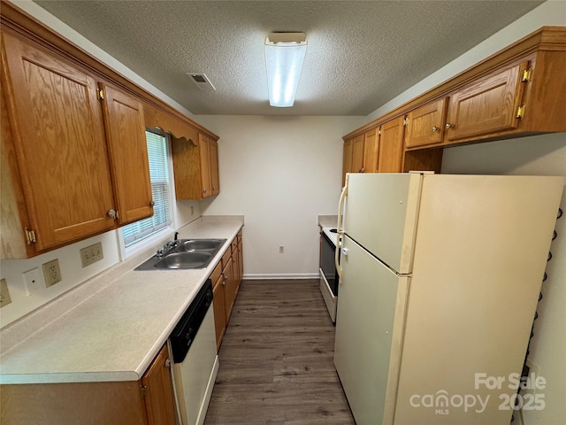 972 NW 8th Ave, Hickory, NC 28601 - kitchen featuring white appliances, dark wood-type flooring, a textured ceiling, brown cabinetry, and light countertops