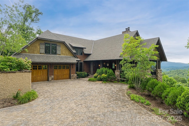 14 Clear Fork Ln, Fairview, NC 28730 - view of front of house with stone siding, a shingled roof, decorative driveway, and a garage