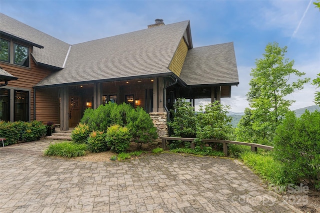 14 Clear Fork Ln, Fairview, NC 28730 - view of front of house with roof with shingles, stone siding, and a chimney