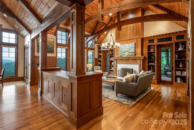 14 Clear Fork Ln, Fairview, NC 28730 - living room with ornate columns, high vaulted ceiling, a wood ceiling with exposed beams, light wood-style floors, and a chandelier