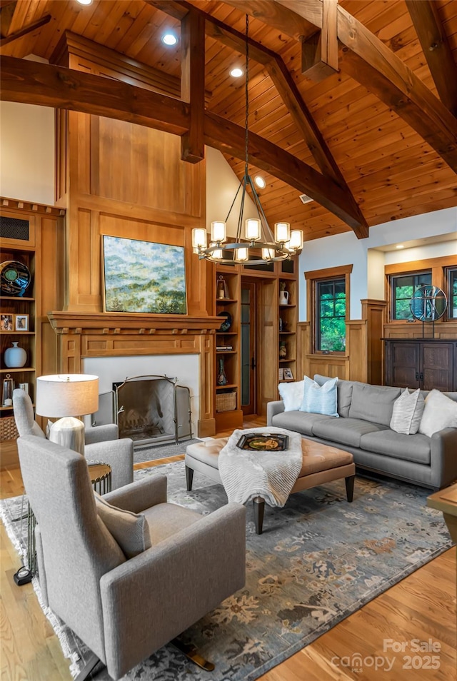 14 Clear Fork Ln, Fairview, NC 28730 - living area with a wooden ceiling with exposed beams, a chandelier, light wood-style floors, a fireplace with flush hearth, and wainscoting