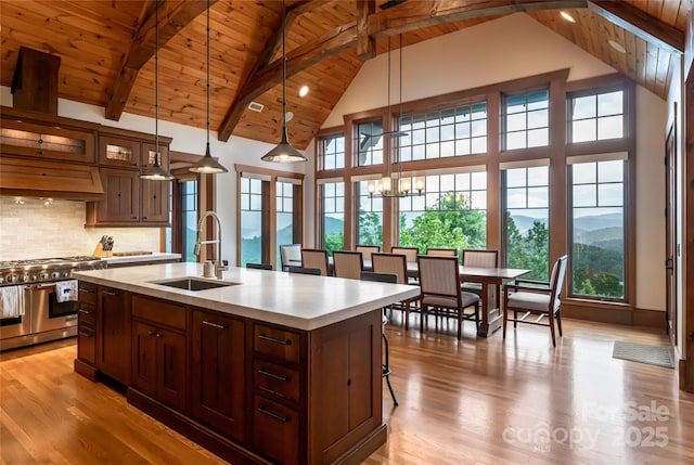 14 Clear Fork Ln, Fairview, NC 28730 - kitchen with range with two ovens, a wood ceiling with exposed beams, high vaulted ceiling, light countertops, and a center island with sink