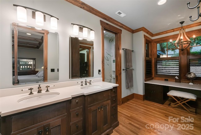 14 Clear Fork Ln, Fairview, NC 28730 - ensuite bathroom with double vanity, wood finished floors, a chandelier, and crown molding