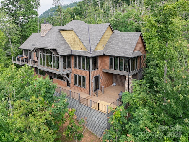 14 Clear Fork Ln, Fairview, NC 28730 - rear view of house featuring a sunroom, a chimney, roof with shingles, and a wooden deck