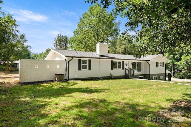 6672 Brevard Rd, Etowah, NC 28729 - back of house with a chimney, a lawn, entry steps, and roof with shingles