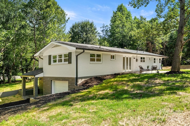 6672 Brevard Rd, Etowah, NC 28729 - view of front of house with a garage, brick siding, a front lawn, and french doors