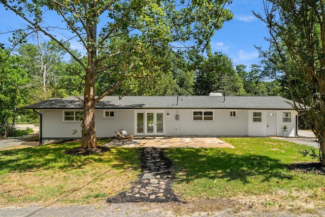 6672 Brevard Rd, Etowah, NC 28729 - back of property with french doors, a lawn, a patio, and a chimney
