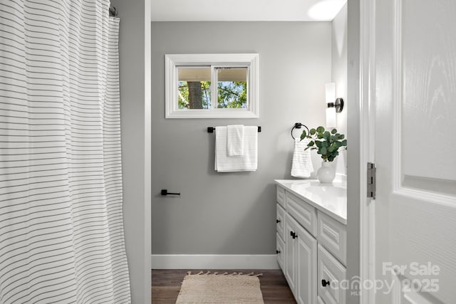 6672 Brevard Rd, Etowah, NC 28729 - full bath featuring vanity, wood finished floors, and a shower with shower curtain