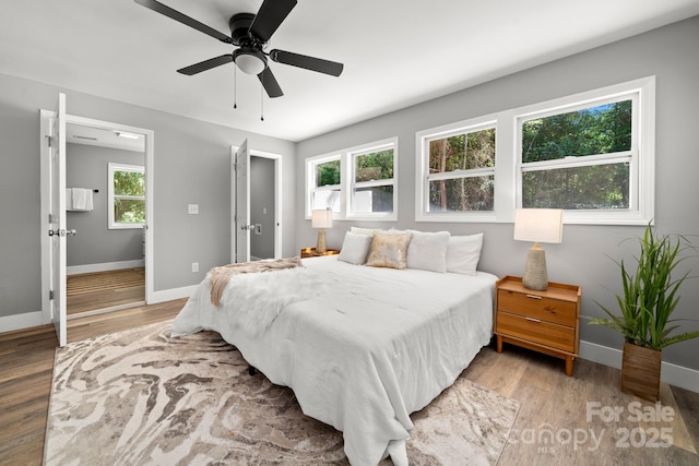 6672 Brevard Rd, Etowah, NC 28729 - bedroom with light wood finished floors and a ceiling fan