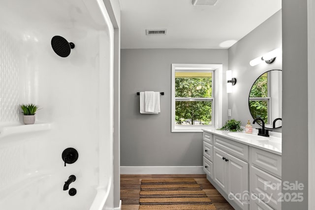 6672 Brevard Rd, Etowah, NC 28729 - bathroom with vanity, wood finished floors, and bathtub / shower combination