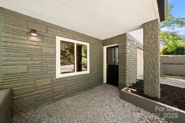 6672 Brevard Rd, Etowah, NC 28729 - view of exterior entry featuring stone siding