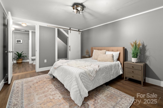 6672 Brevard Rd, Etowah, NC 28729 - bedroom featuring a barn door, wood finished floors, and ensuite bathroom