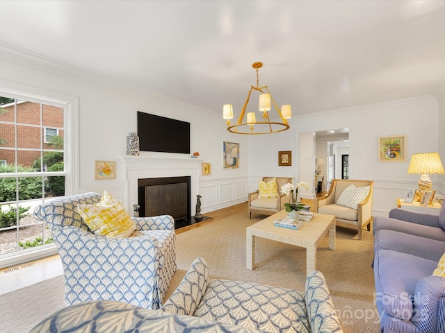 2912 Wheelock Rd, Charlotte, NC 28211 - living area featuring ornamental molding, a chandelier, a decorative wall, a glass covered fireplace, and wainscoting