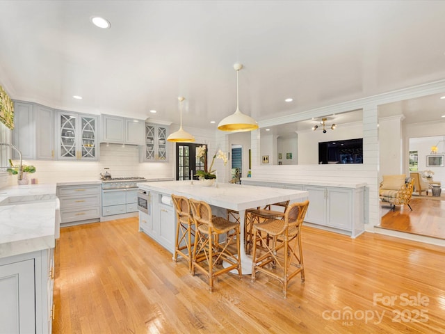 2912 Wheelock Rd, Charlotte, NC 28211 - kitchen with recessed lighting, light wood-type flooring, backsplash, glass insert cabinets, and ornamental molding
