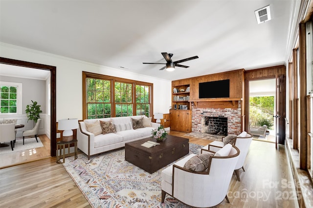 197 Briar Patch Rd, Cullowhee, NC 28723 - living area with light wood-style flooring, ceiling fan, a fireplace, and crown molding
