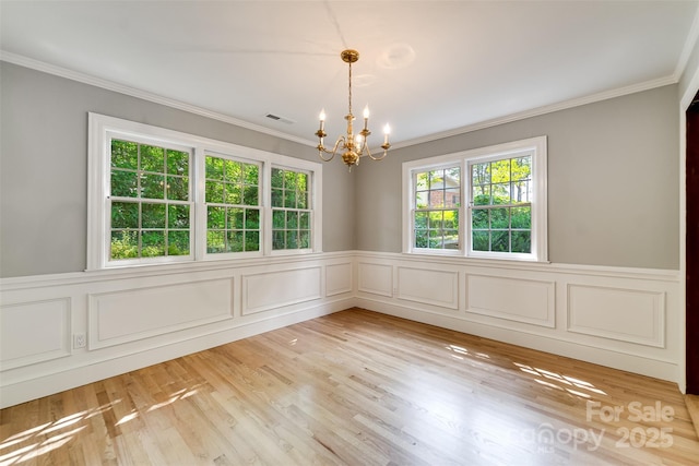 197 Briar Patch Rd, Cullowhee, NC 28723 - empty room featuring a chandelier, ornamental molding, a wainscoted wall, light wood-type flooring, and a decorative wall
