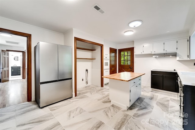 197 Briar Patch Rd, Cullowhee, NC 28723 - kitchen with freestanding refrigerator, wood counters, white cabinetry, a kitchen island, and under cabinet range hood