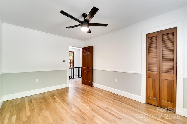 197 Briar Patch Rd, Cullowhee, NC 28723 - unfurnished bedroom with light wood-type flooring, crown molding, a closet, and a ceiling fan