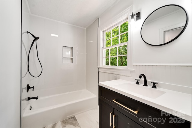 197 Briar Patch Rd, Cullowhee, NC 28723 - full bathroom featuring vanity, crown molding, bathtub / shower combination, a wainscoted wall, and marble look tiles