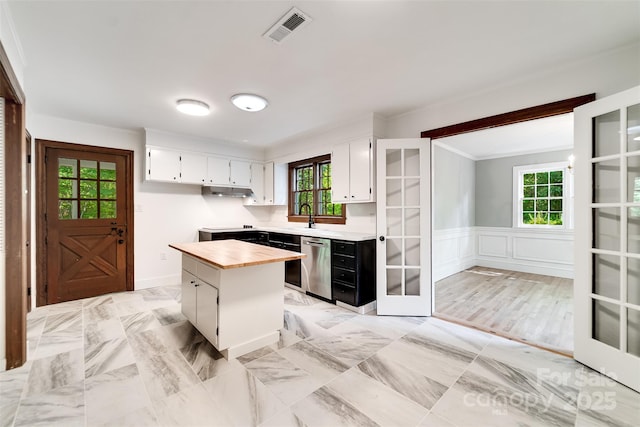 197 Briar Patch Rd, Cullowhee, NC 28723 - kitchen with healthy amount of natural light, white cabinets, stainless steel dishwasher, a kitchen island, and wainscoting