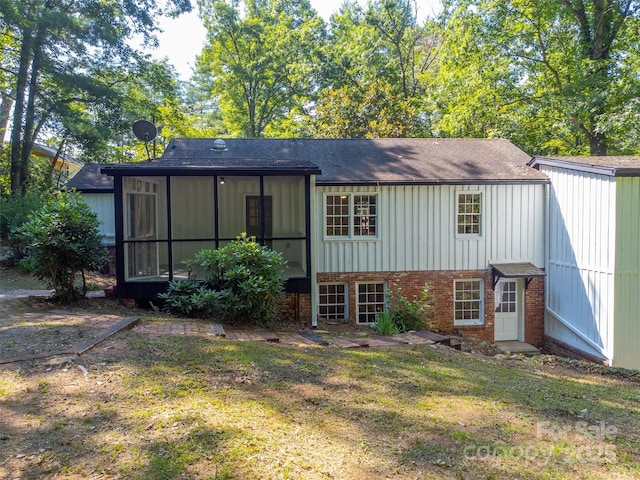 197 Briar Patch Rd, Cullowhee, NC 28723 - back of house with brick siding, a sunroom, board and batten siding, and a yard