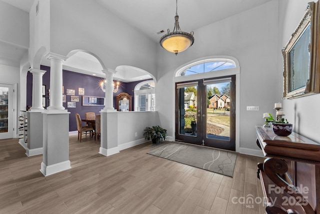 543 Muirfield Way, Salisbury, NC 28144 - entrance foyer with decorative columns, a towering ceiling, wood finished floors, french doors, and arched walkways