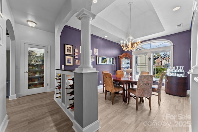 543 Muirfield Way, Salisbury, NC 28144 - dining room featuring decorative columns, light wood finished floors, a raised ceiling, a chandelier, and recessed lighting