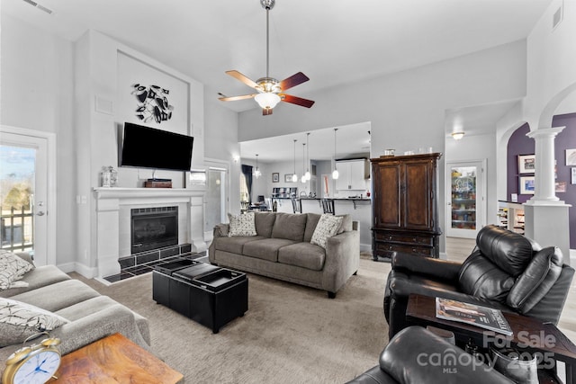543 Muirfield Way, Salisbury, NC 28144 - living room with a towering ceiling, arched walkways, a ceiling fan, decorative columns, and a fireplace