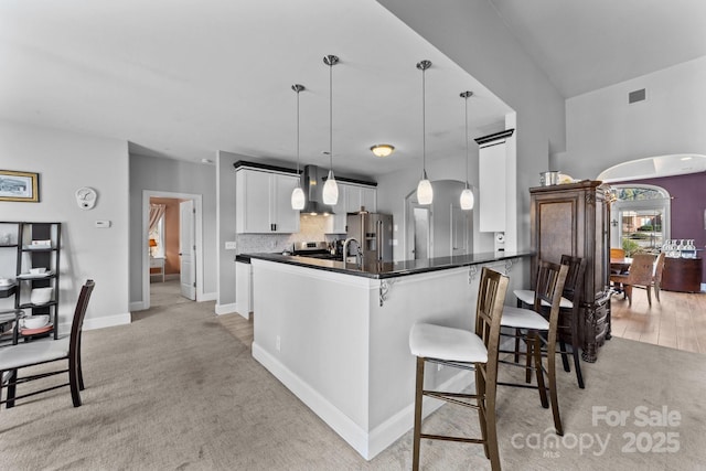 543 Muirfield Way, Salisbury, NC 28144 - kitchen with light colored carpet, dark countertops, a breakfast bar, and white cabinets