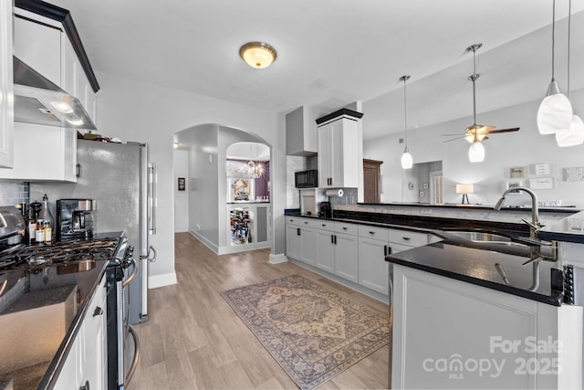 543 Muirfield Way, Salisbury, NC 28144 - kitchen featuring range with gas stovetop, exhaust hood, arched walkways, a ceiling fan, and pendant lighting
