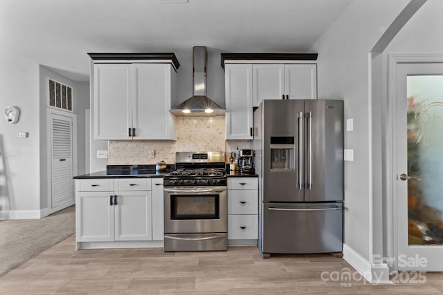 543 Muirfield Way, Salisbury, NC 28144 - kitchen with stainless steel appliances, wall chimney range hood, dark countertops, tasteful backsplash, and white cabinetry