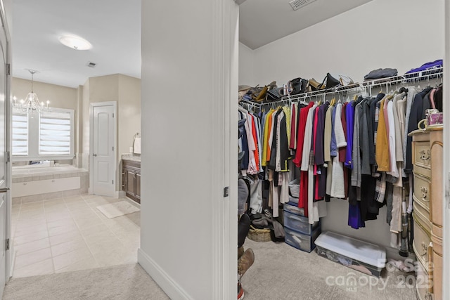 543 Muirfield Way, Salisbury, NC 28144 - spacious closet featuring a chandelier, light colored carpet, and light tile patterned flooring
