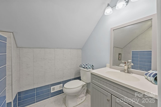 543 Muirfield Way, Salisbury, NC 28144 - bathroom featuring vaulted ceiling, vanity, tile walls, and marble finish floors