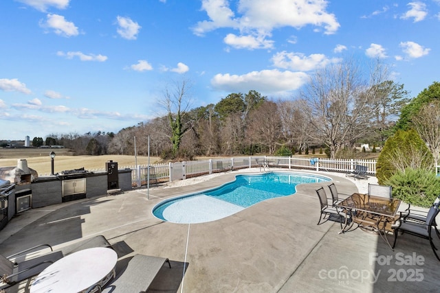 543 Muirfield Way, Salisbury, NC 28144 - view of swimming pool with a patio area, an outdoor kitchen, and view of wooded area
